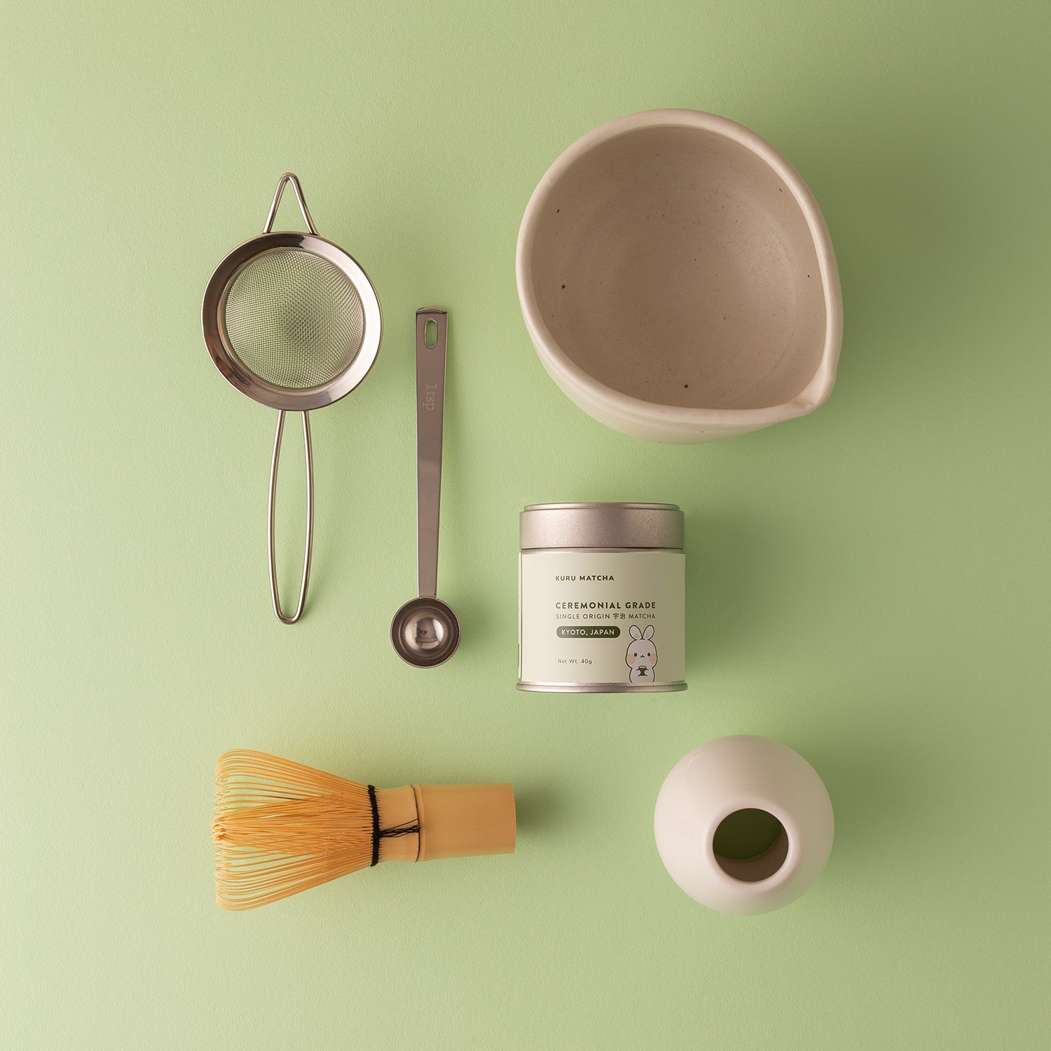 Flat-lay view of a premium matcha kit, including ceremonial matcha powder, whisk, matcha bowl, and essentials available to buy in Australia