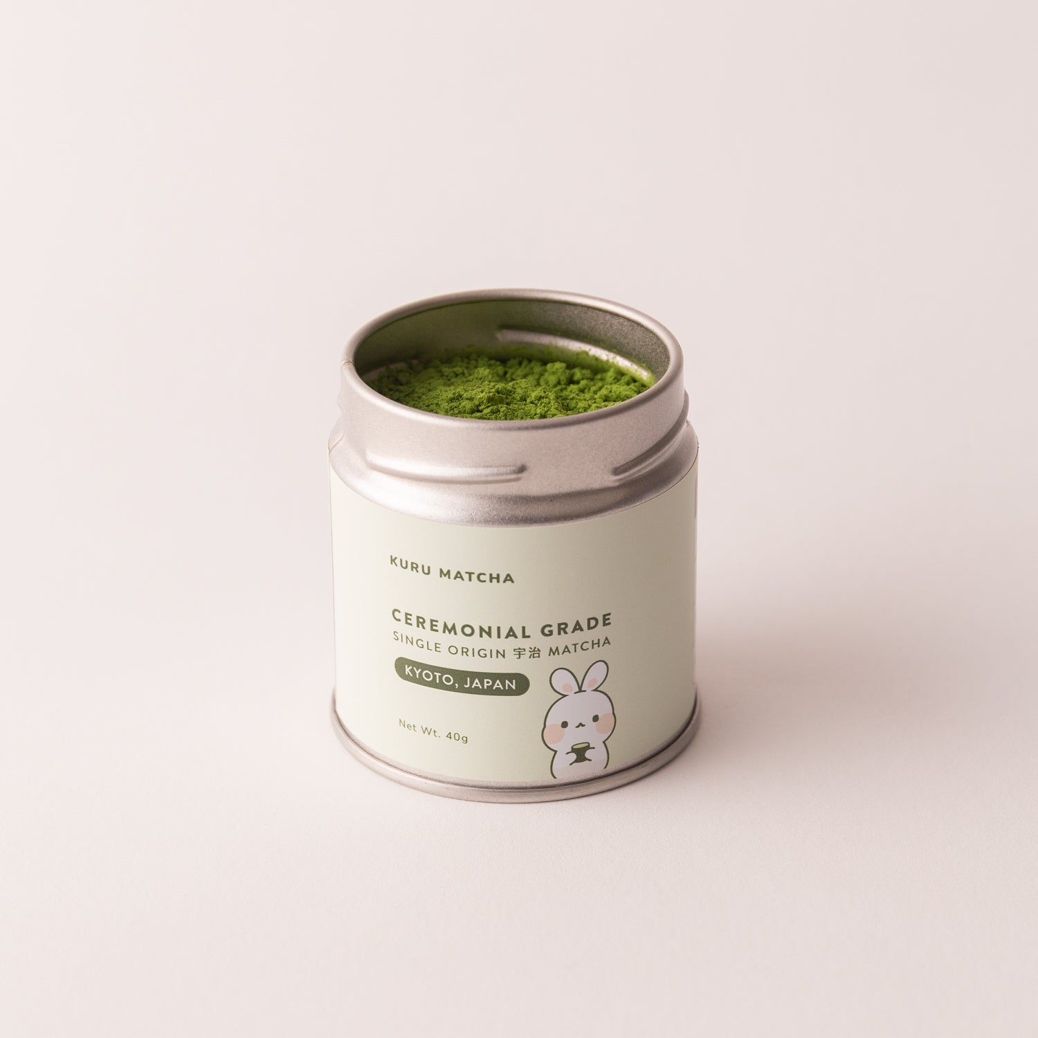 Ceremonial matcha powder in tin with lid off, showcasing its vibrant rich green colour